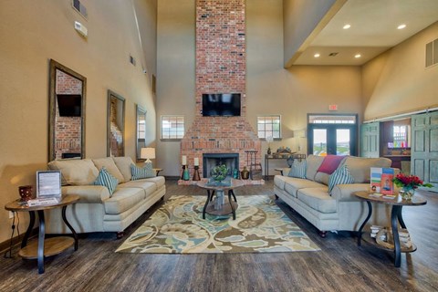 a large living room with couches and a fireplace