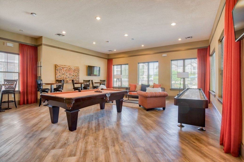 Club house with chairs and couches and pool table