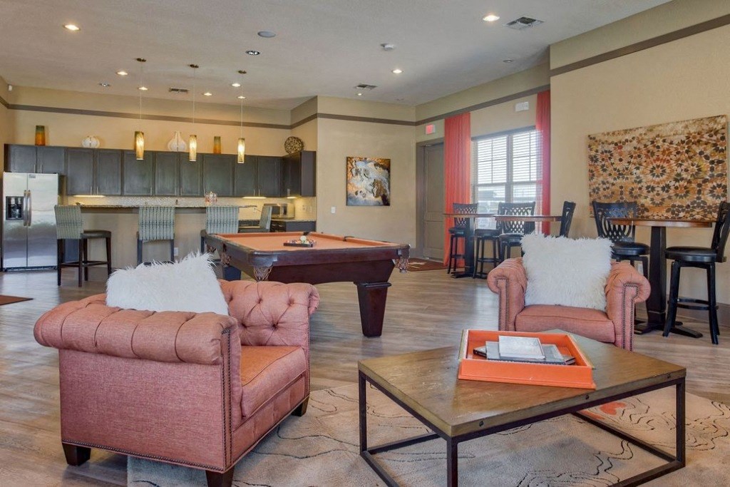 Area for relaxing with an island and chairs and mini kitchen and couches and chairs