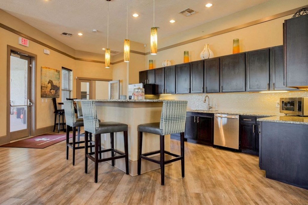 Area for relaxing with an island and chairs and mini kitchen