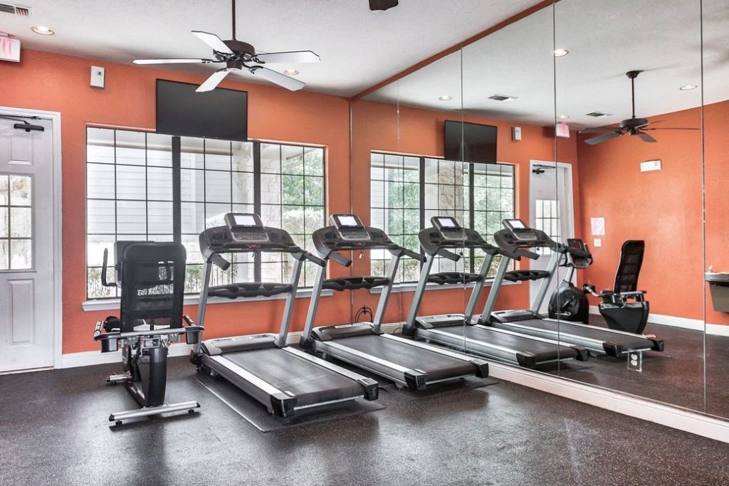 Fitness center with large windows and cardio equipment