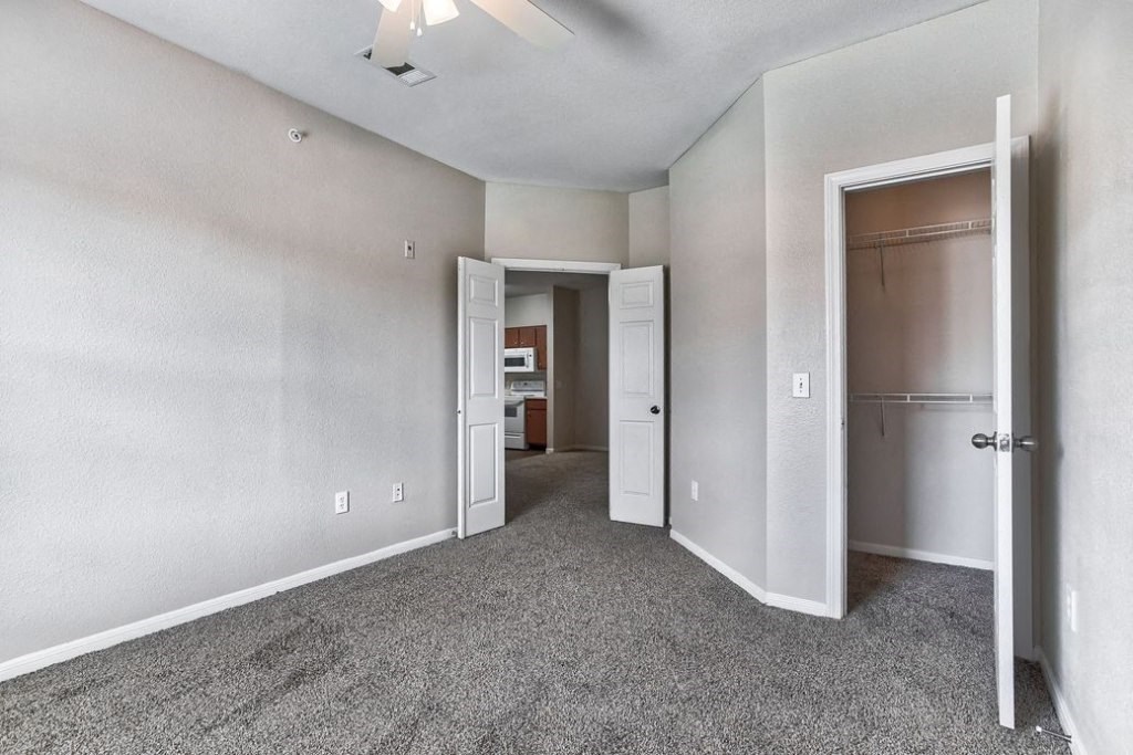 Bed room with white doors and closet and carpet floor