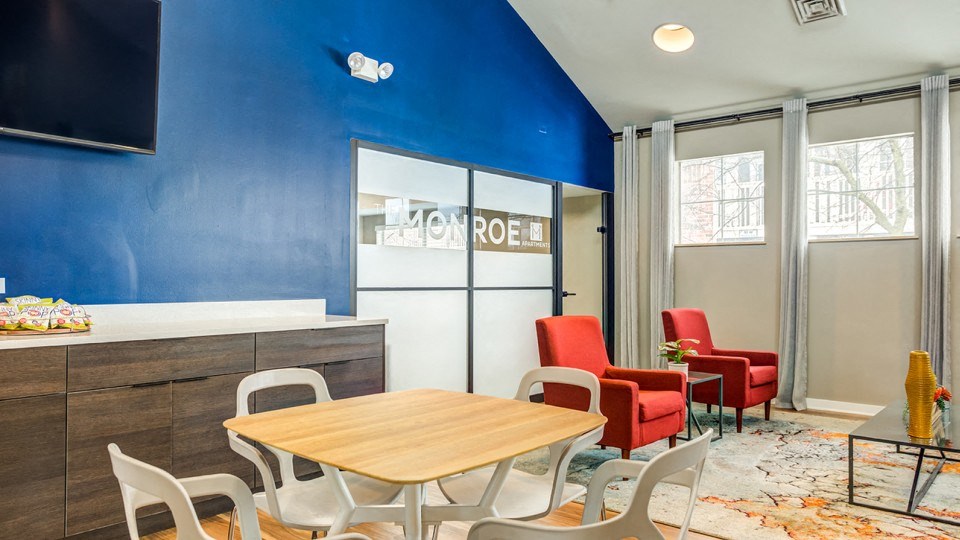 a dining room with a table and chairs and a tv