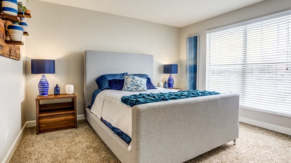 a bedroom with a large bed and a window