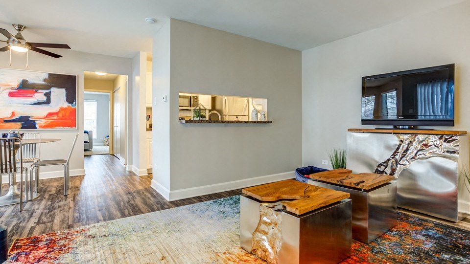 an open living room with a tv and a dining room table