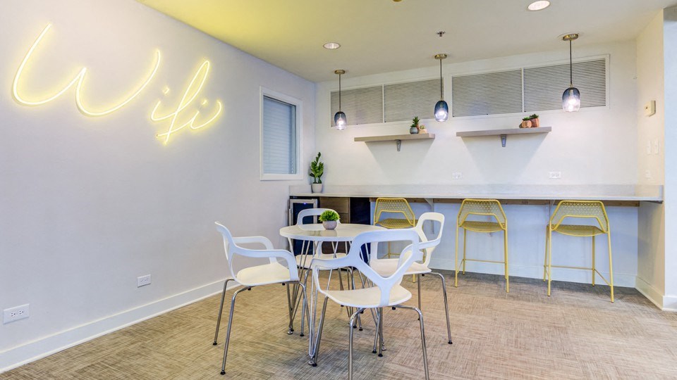 a dining room with a table and chairs and a bar