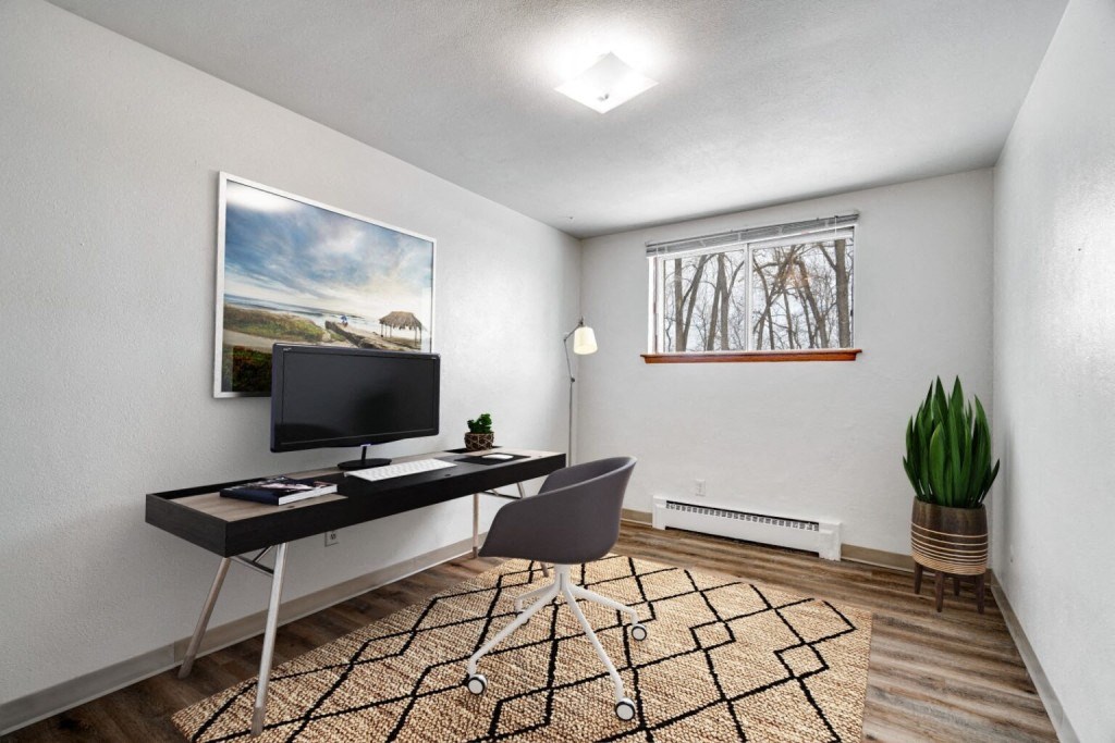 an office with a computer desk and a window