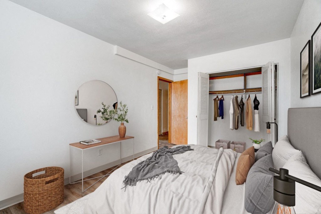 a bedroom with a bed and a closet with a mirror
