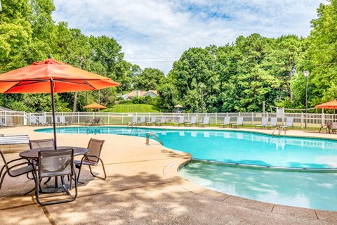 Swimming pool with lounge seating at Grand Arbor Reserve Apartments in Raleigh, NC 27607, near Central Raleigh.