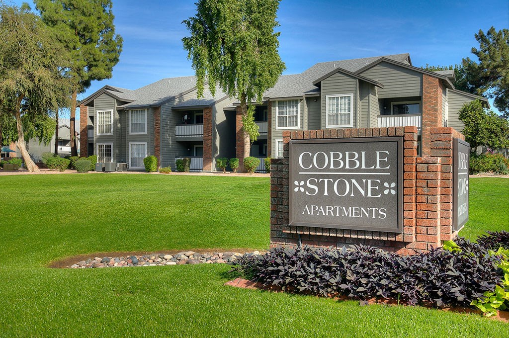 an apartment building with a sign for cobble stone apartments