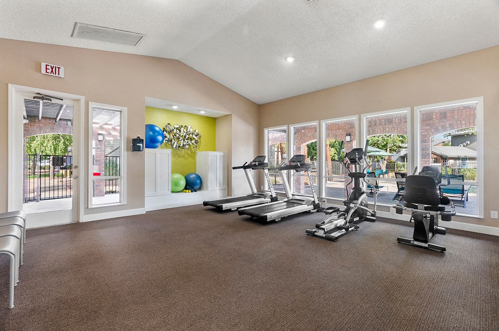 Apartments for Rent in North Phoenix, AZ - Cobblestone - A Bright And Spacious Fitness Center With Multiple Exercise Machines And Large Windows Facing Towards The Pool Area