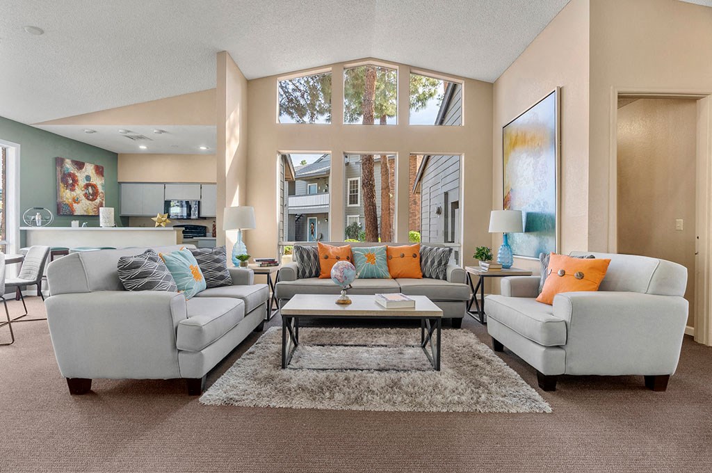 a living room with couches and chairs and a table