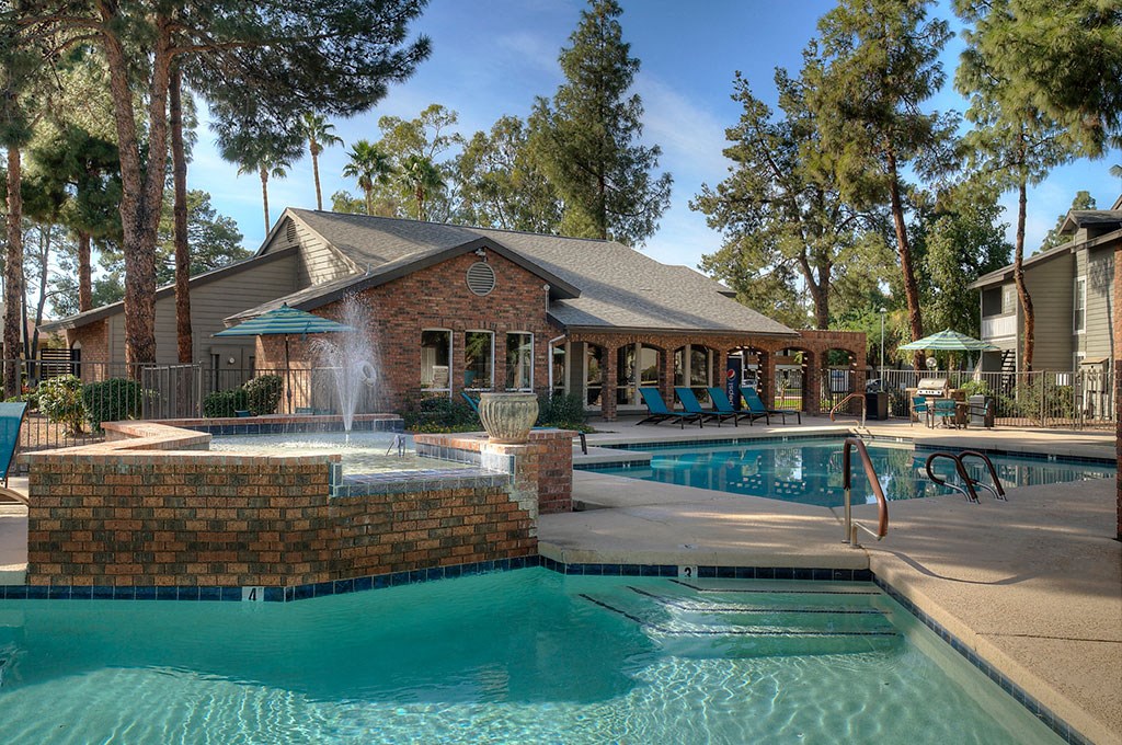 the swimming pool at the resort with a building in the background