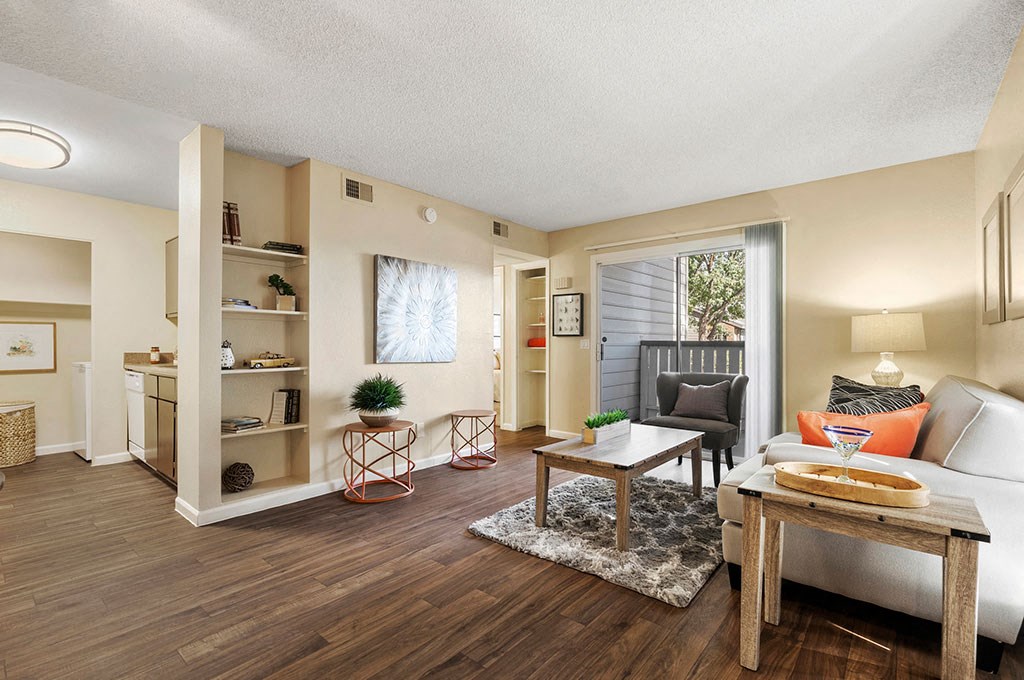 North Phoenix, AZ Apartments for Rent - Cobblestone - A Spacious Living Room With A Sliding Glass Door Leading To A Patio, Wood-Style Flooring, And Enough Room For All Your Furniture