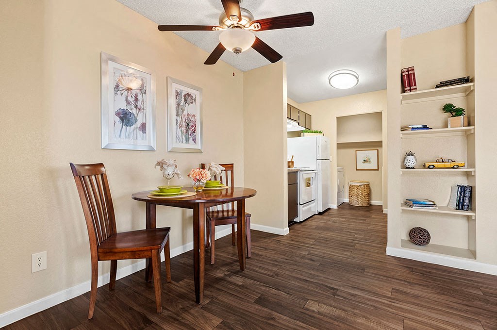 a dining room with a table and a ceiling fan