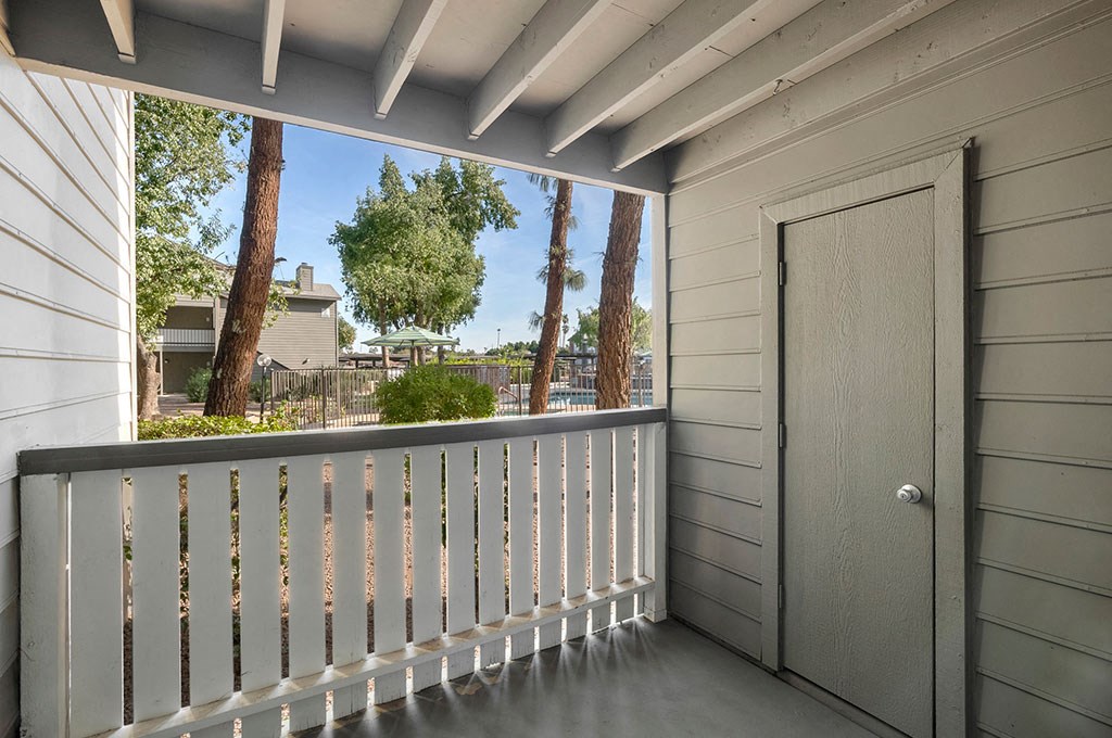 the deck has a door to the yard and a view of the street