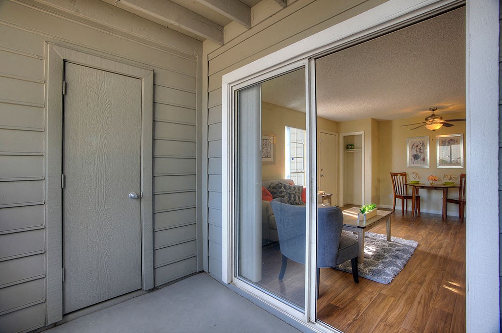 a living room and dining room with sliding glass doors