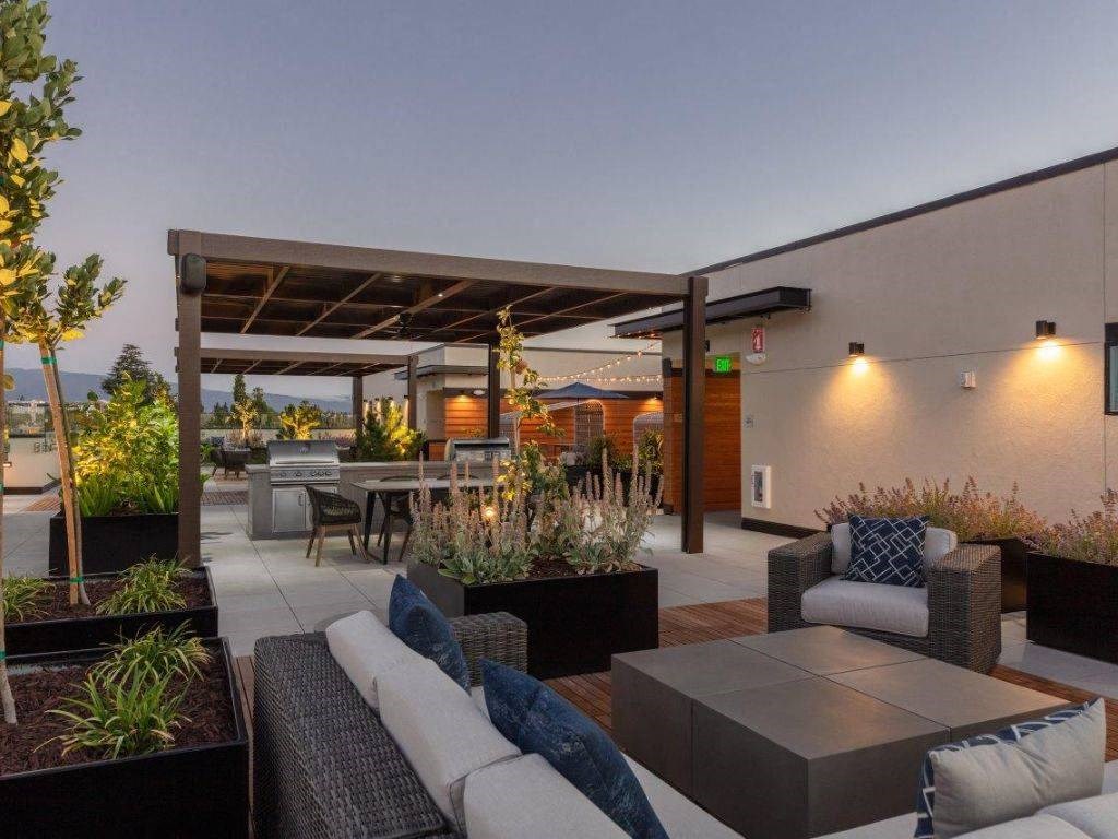 a modern patio with furniture and a roof