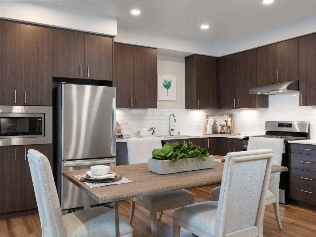 2-Bedroom Apartments in Santa Clara, CA - Santana Terrace - Kitchen with Stainless Steel Appliances, Dark Brown Cabinetry, and Modern Hardware