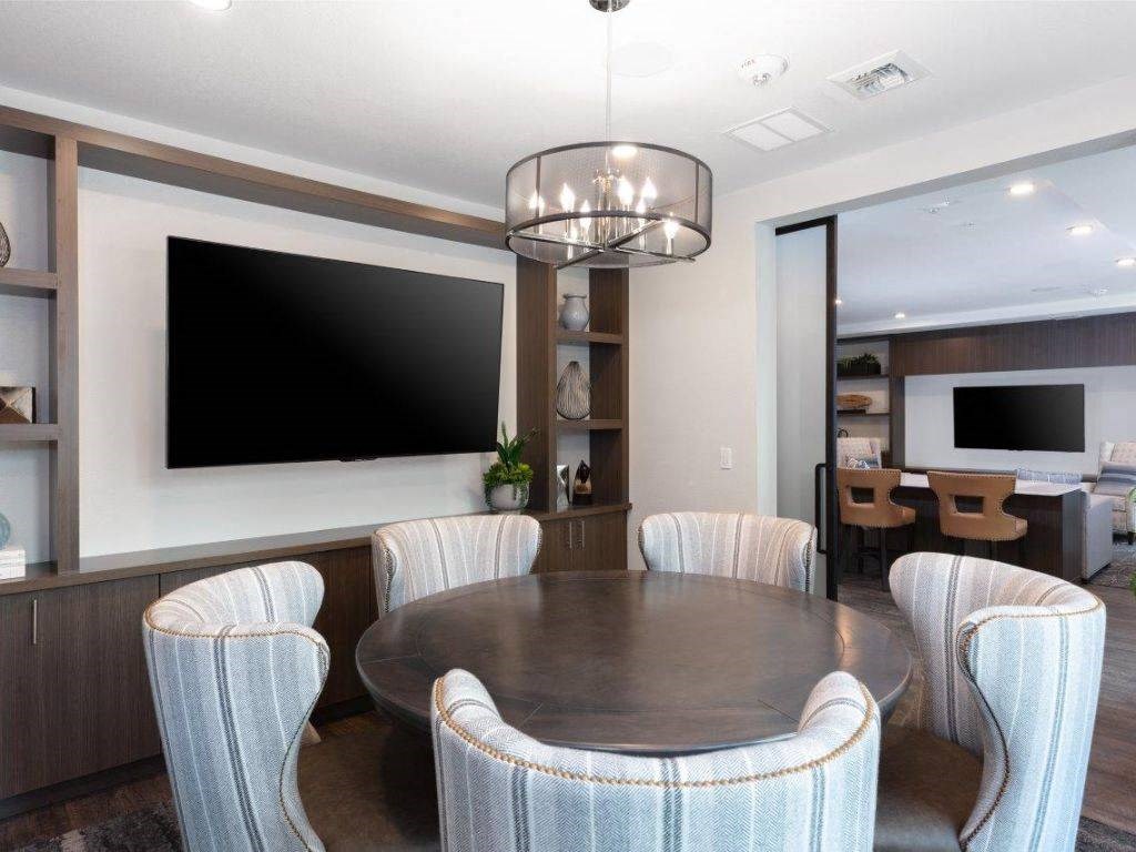 a dining room with a table and chairs and a television