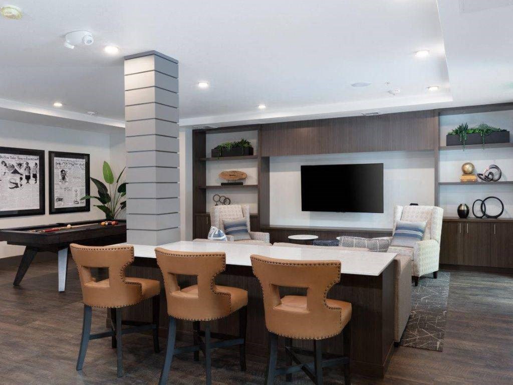 Apartments Near Santan Row in Santa Clara, CA - Santana Terrace - Game Room with a Pool Table, a TV, and Comfortable Seating