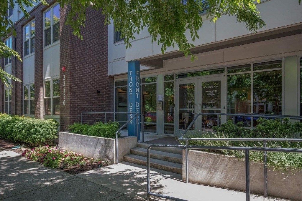 a building with stairs and a sidewalk in front of it