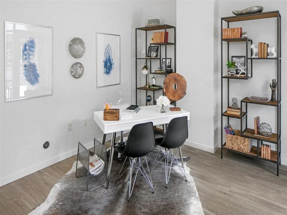 2-Bedroom Apartments in Beaverton, OR - Westline - Home Office with Vinyl Hardwood Flooring, Area Rug, Desk, Chairs, Wall Art, and Display Shelves.