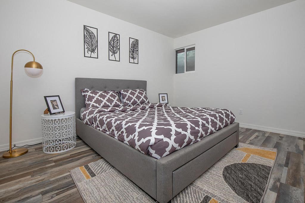 a bedroom with a bed and a lamp