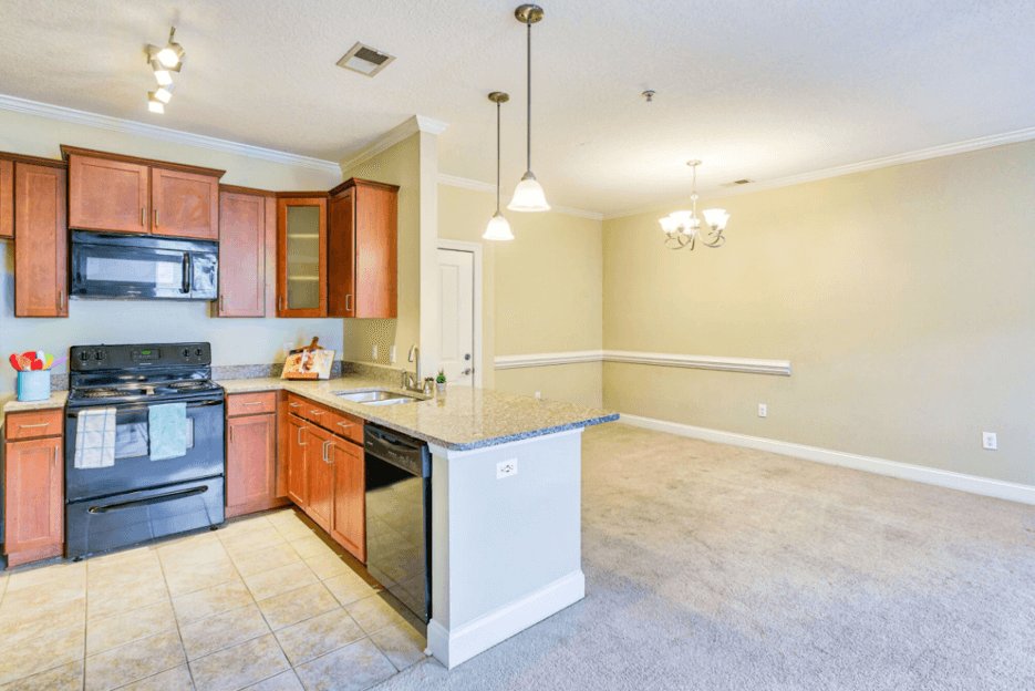 large dinning room with chandelier overlooking the kitchen
