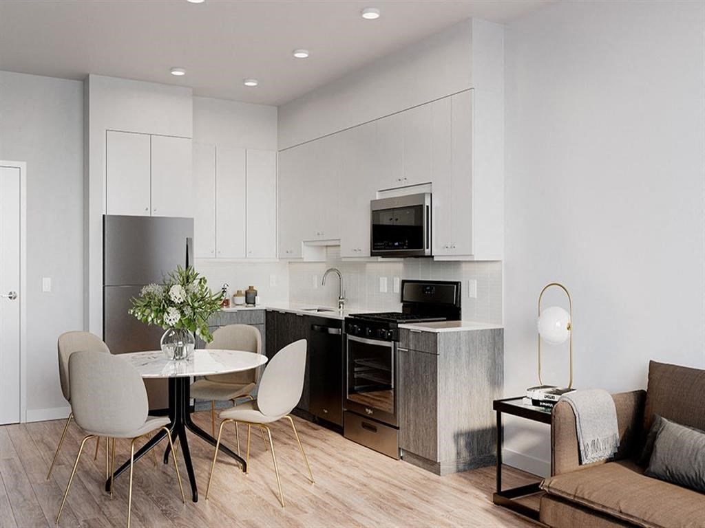 a kitchen and dining room with a table and chairs
