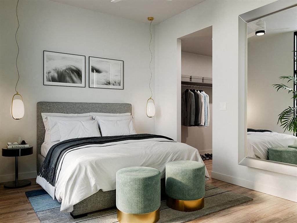 a bedroom with a bed and a mirror