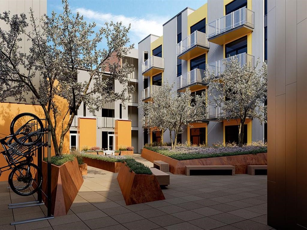 a row of apartments with a courtyard with a bike