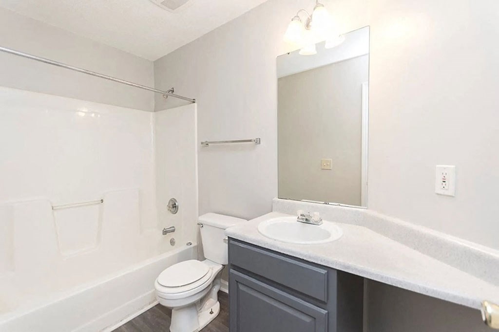 a bathroom with a sink toilet and a mirror