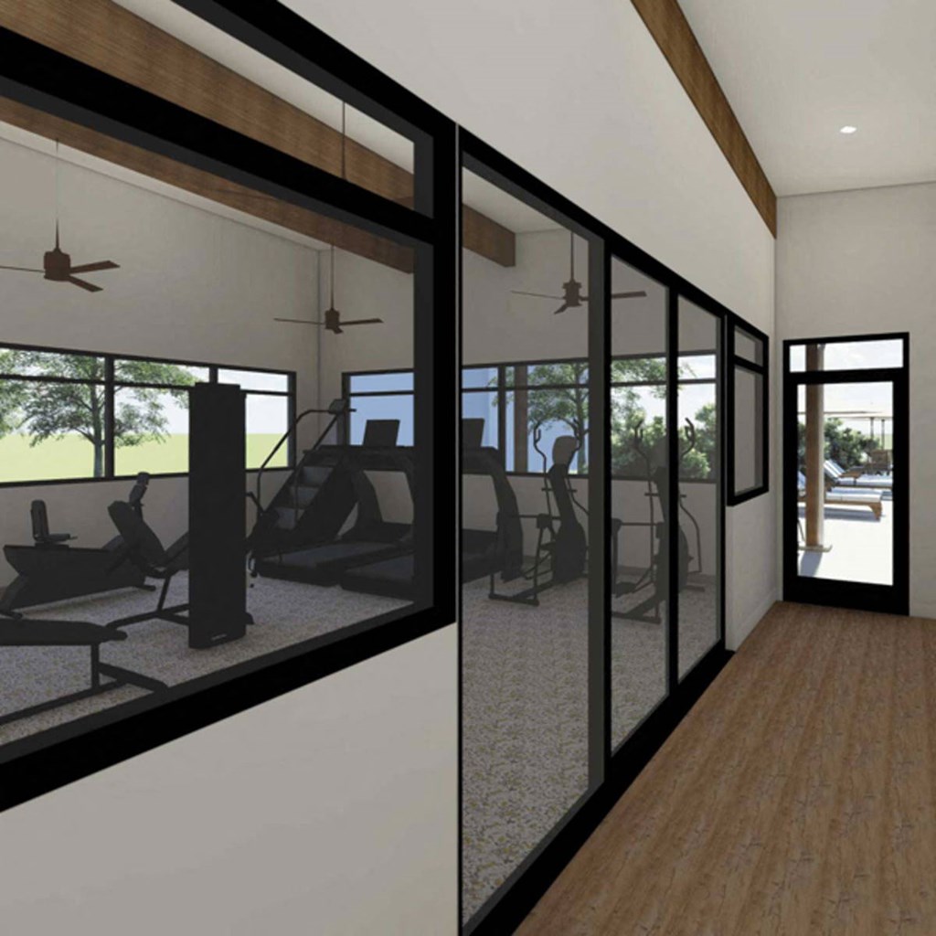 a gym with glass walls and a wood floor