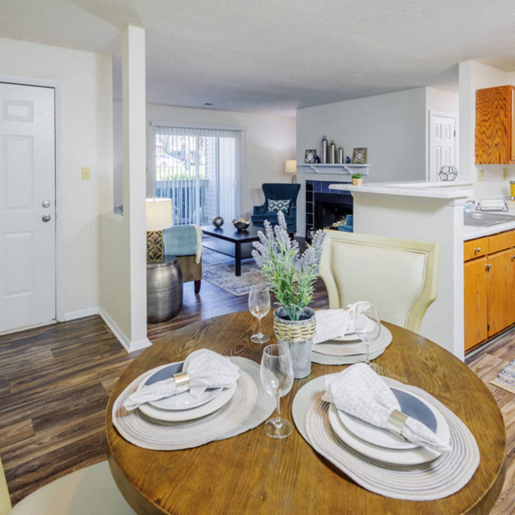a dining room and living room with a table and chairs