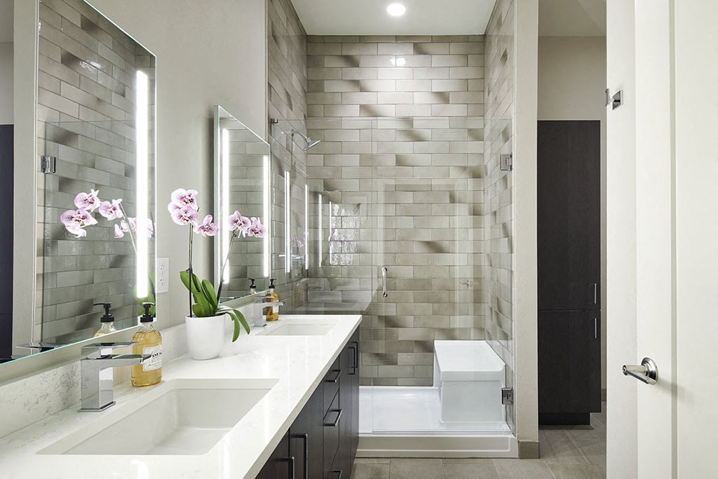 a bathroom with two sinks and a shower and a toilet