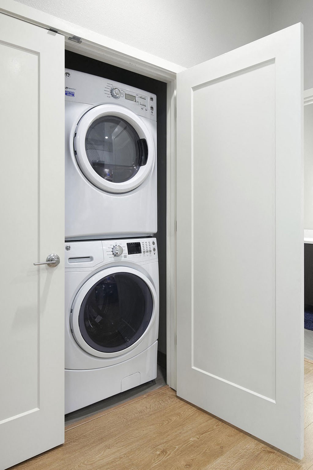 a white washer and dryer in a small laundry room