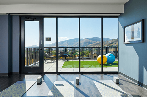 a view of the mountains from a living room with glass doors