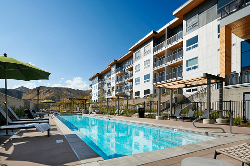 a swimming pool in front of an apartment building