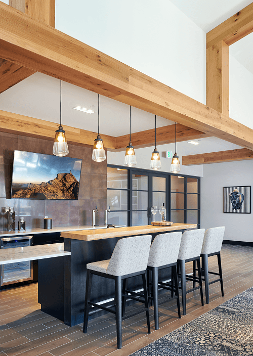 a kitchen with a bar and chairs