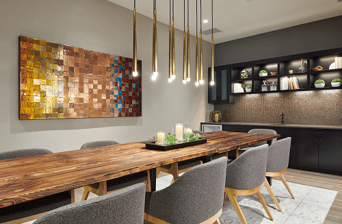 a dining room with a long wooden table and chairs