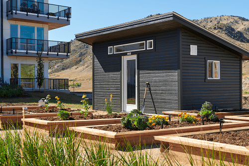 a small house with a garden in front of it