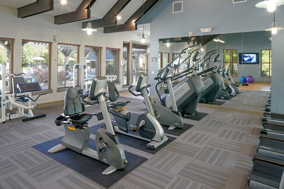 a gym with treadmills and other exercise equipment at the enclave at woodbury