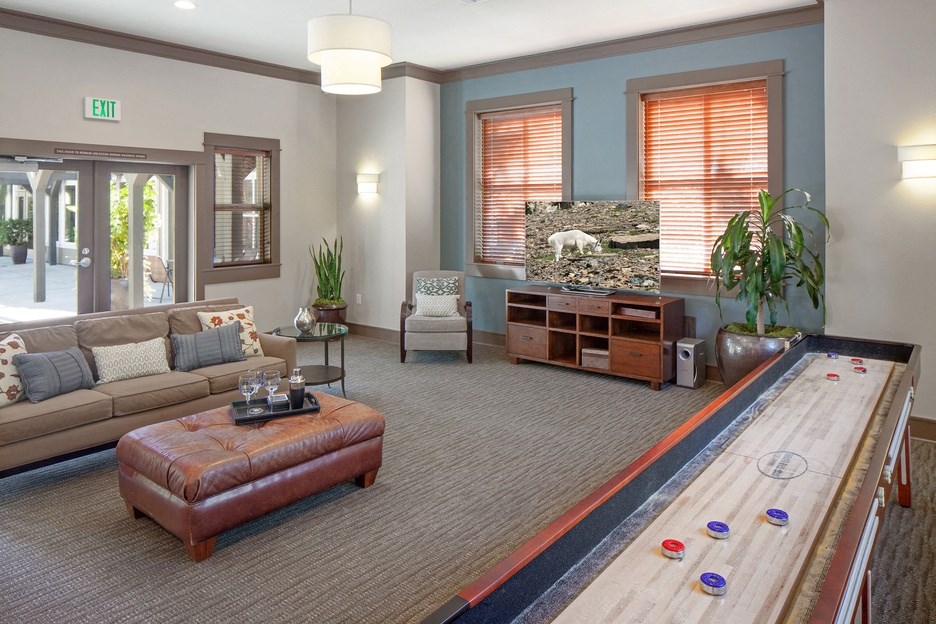 a bowling alley in a living room with a couch and a table
