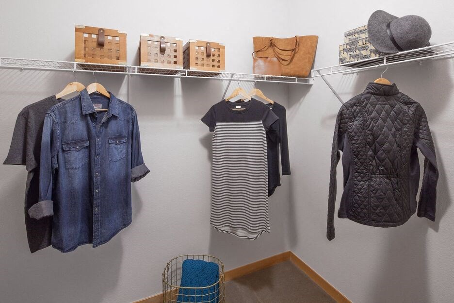a display of denim jackets and clothing hanging on a wall