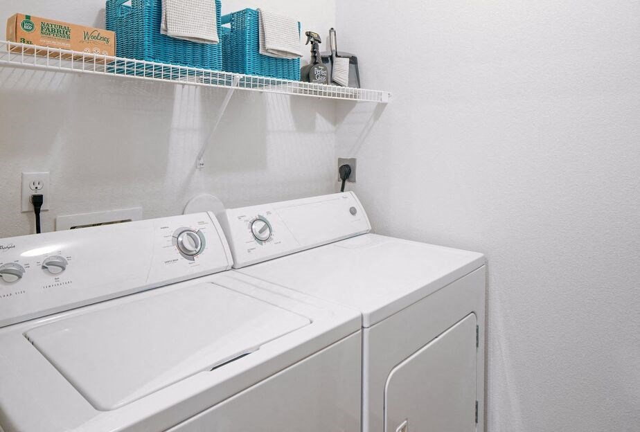 a white washer and dryer in a laundry room