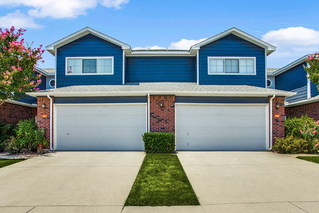 a house with blue siding and a white garage door