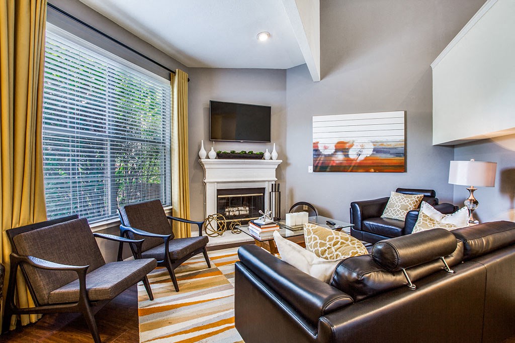 a living room with couches chairs and a fireplace