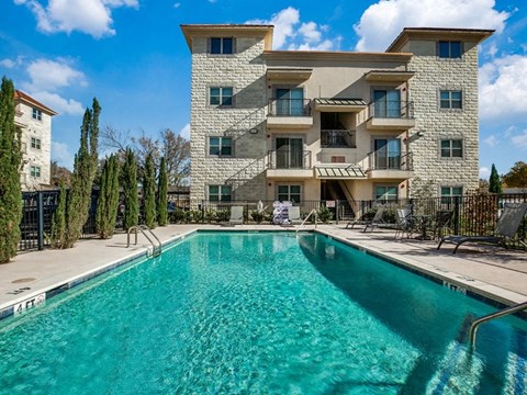 a swimming pool with a building in the background