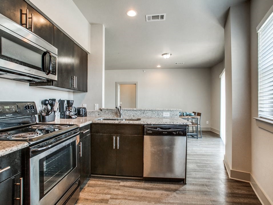 a kitchen with stainless steel appliances and granite countertops